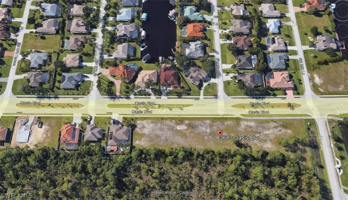 an aerial view of residential houses with outdoor space and swimming pool