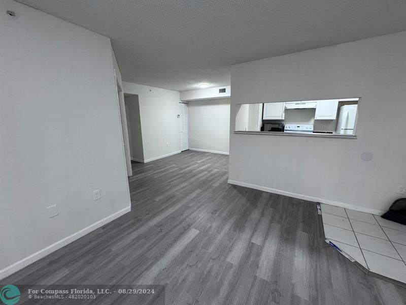 a view of a room with wooden floor