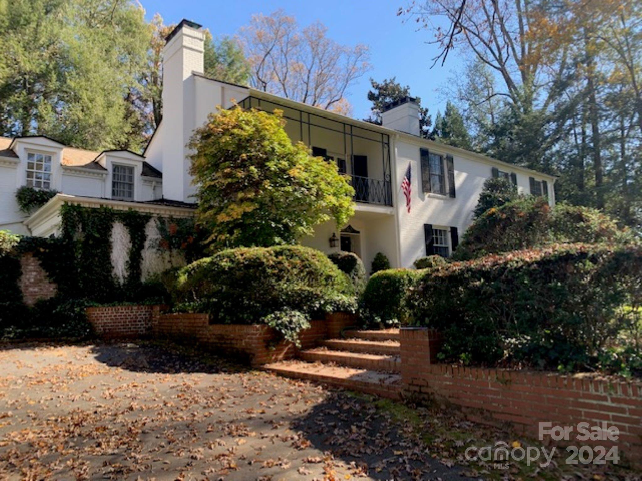 a view of a white house with a yard