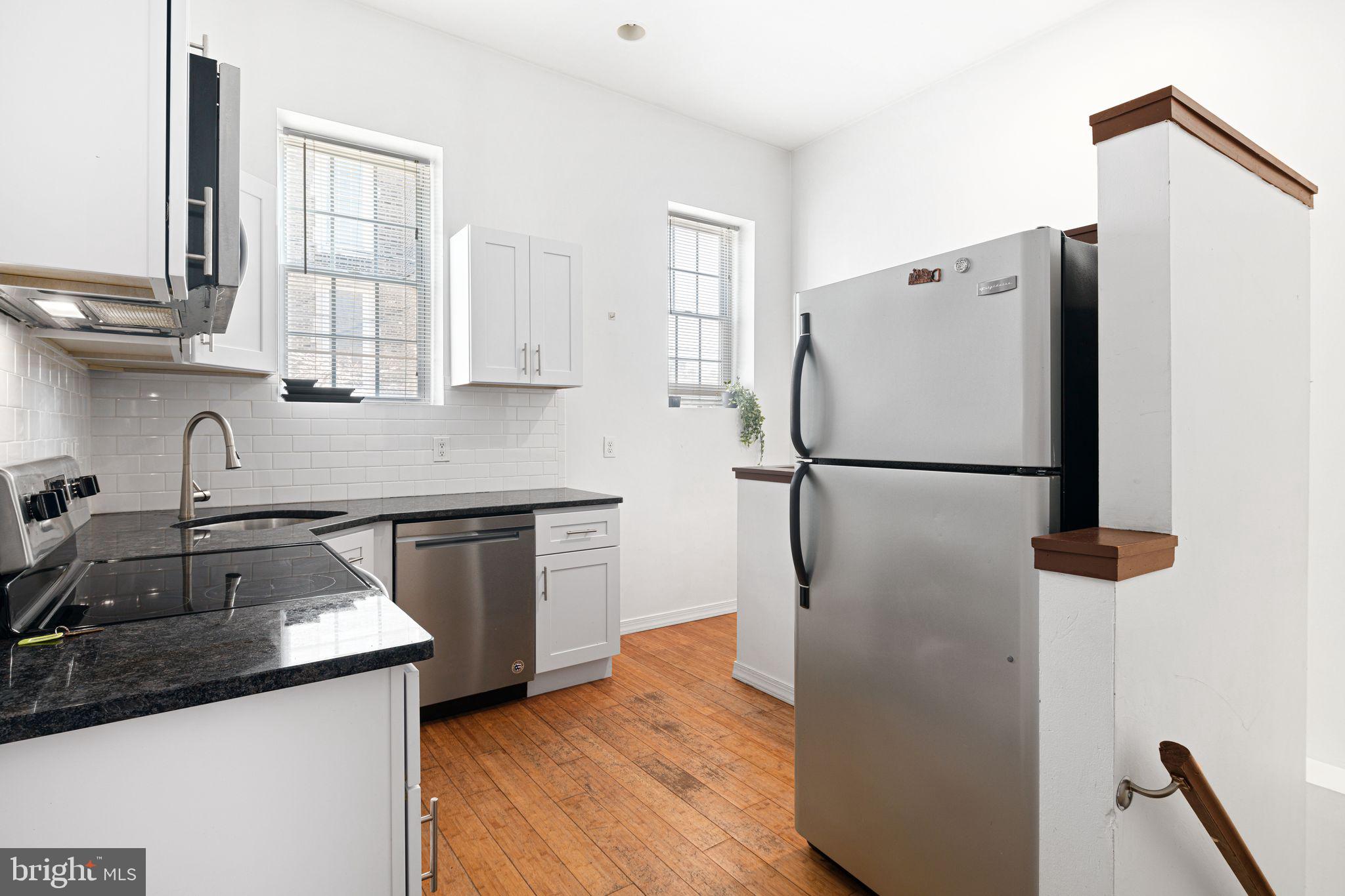 a kitchen with a refrigerator sink and stove