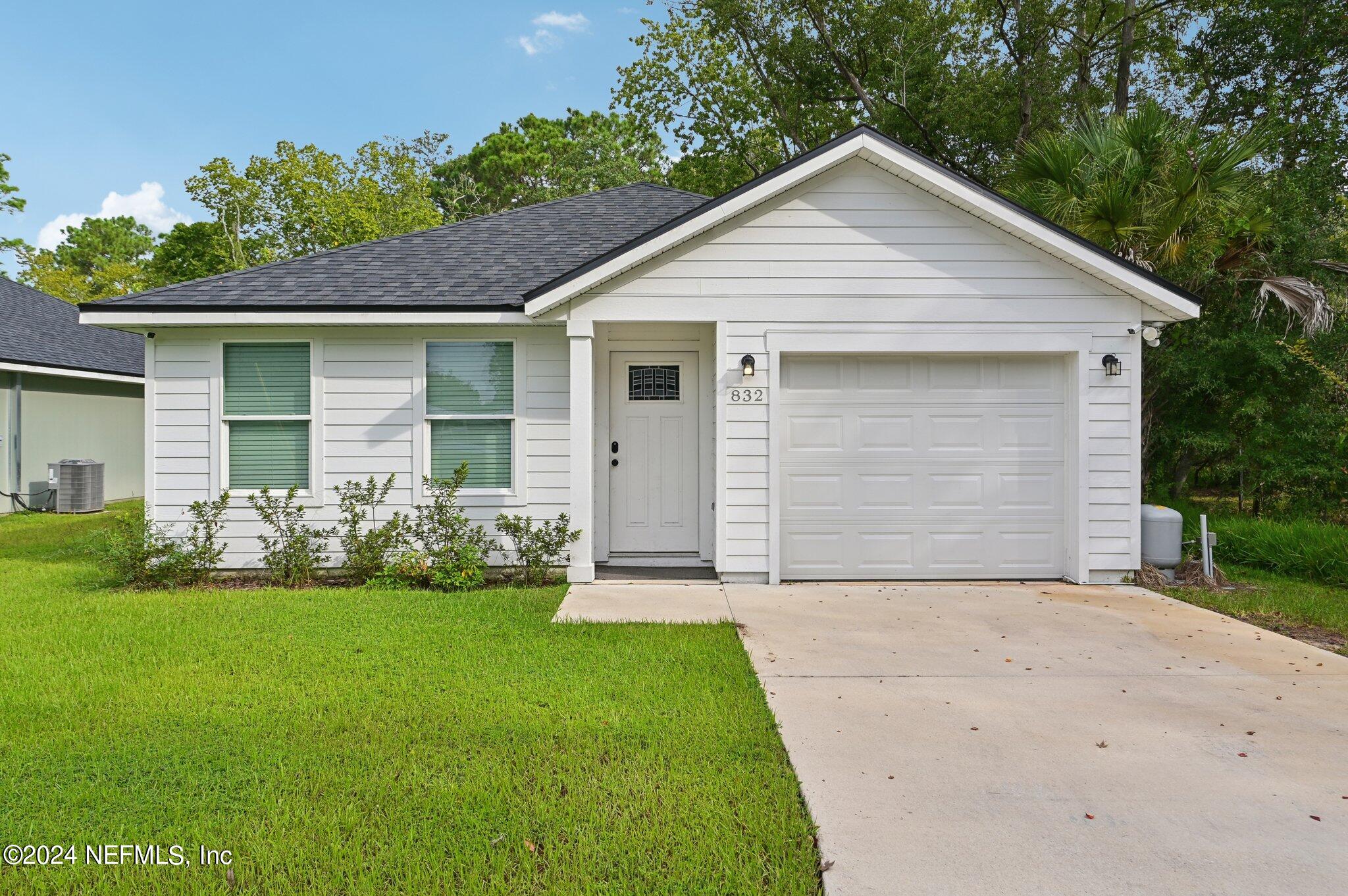 a front view of house with yard and green space