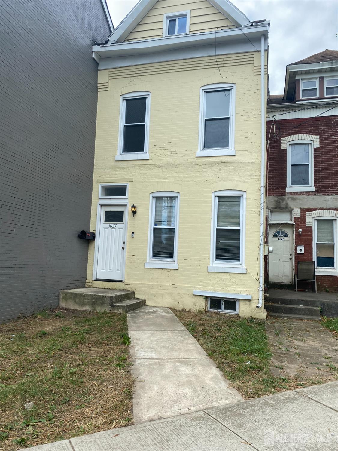 a view of a brick house with many windows