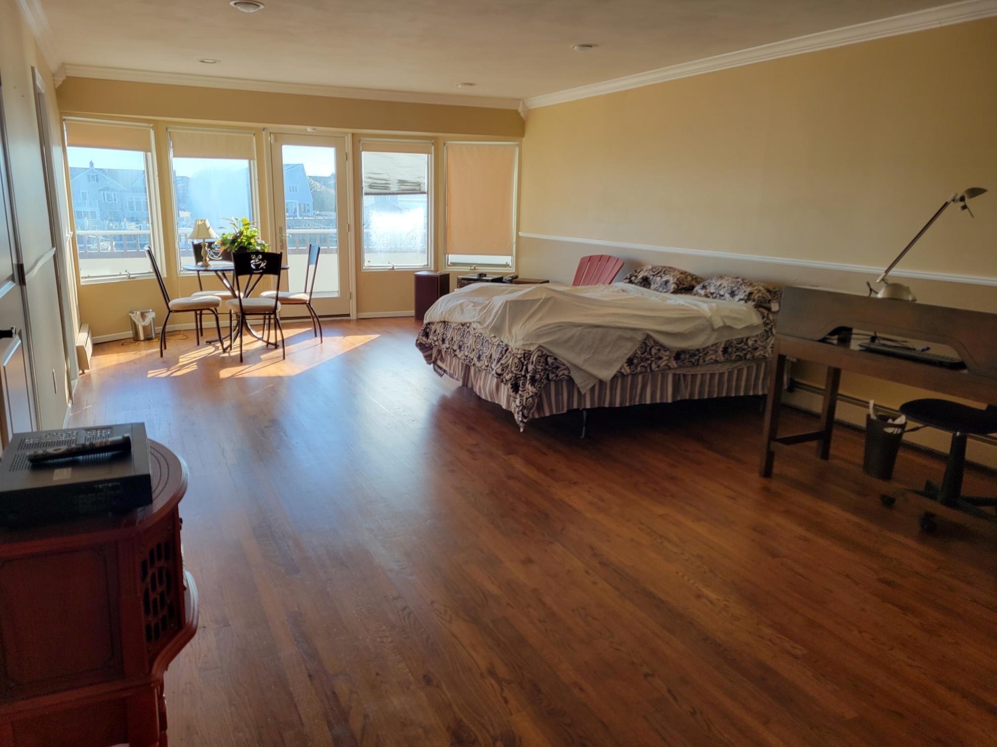 a bedroom with furniture and large windows