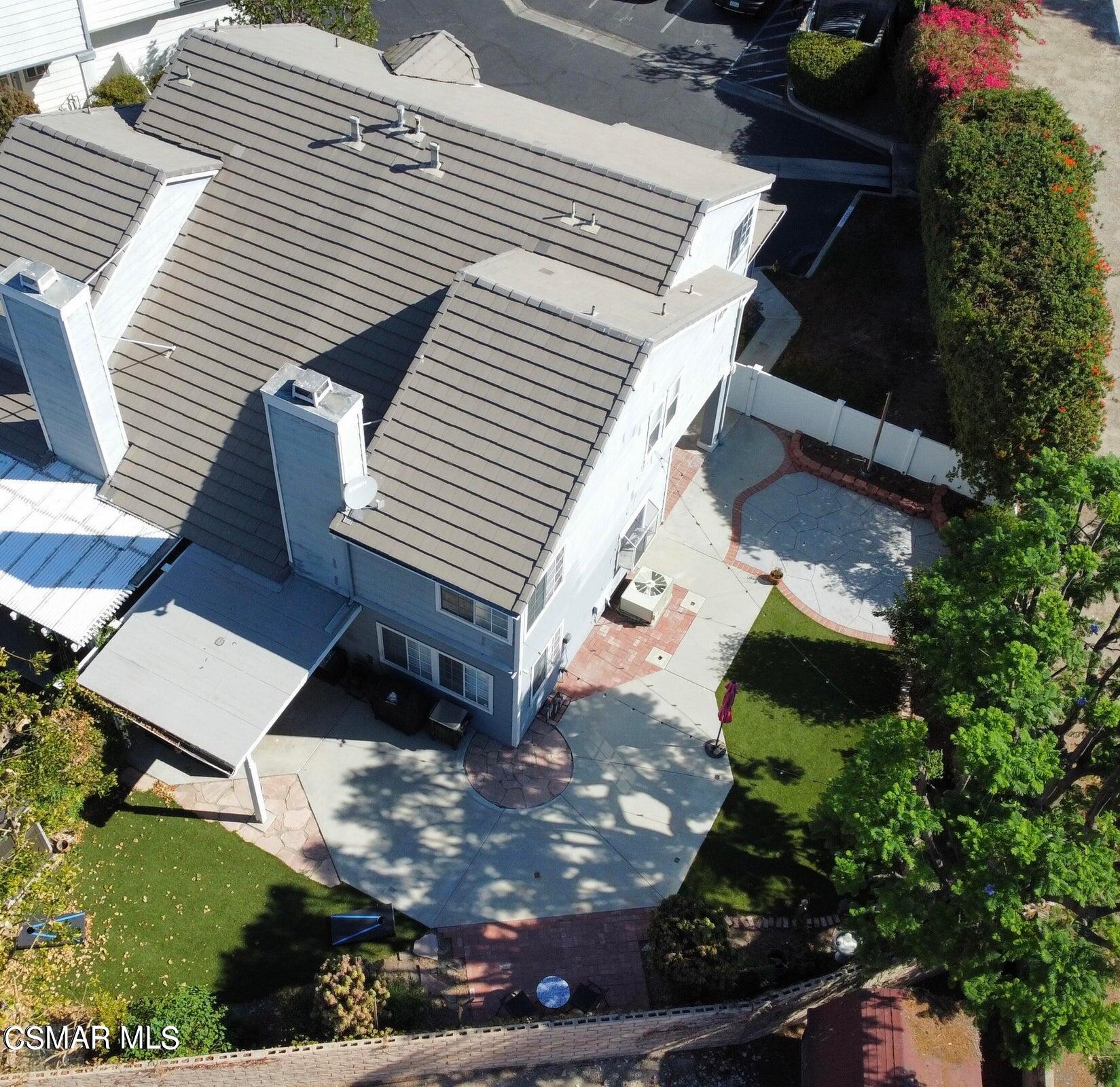 an aerial view of a house with a yard