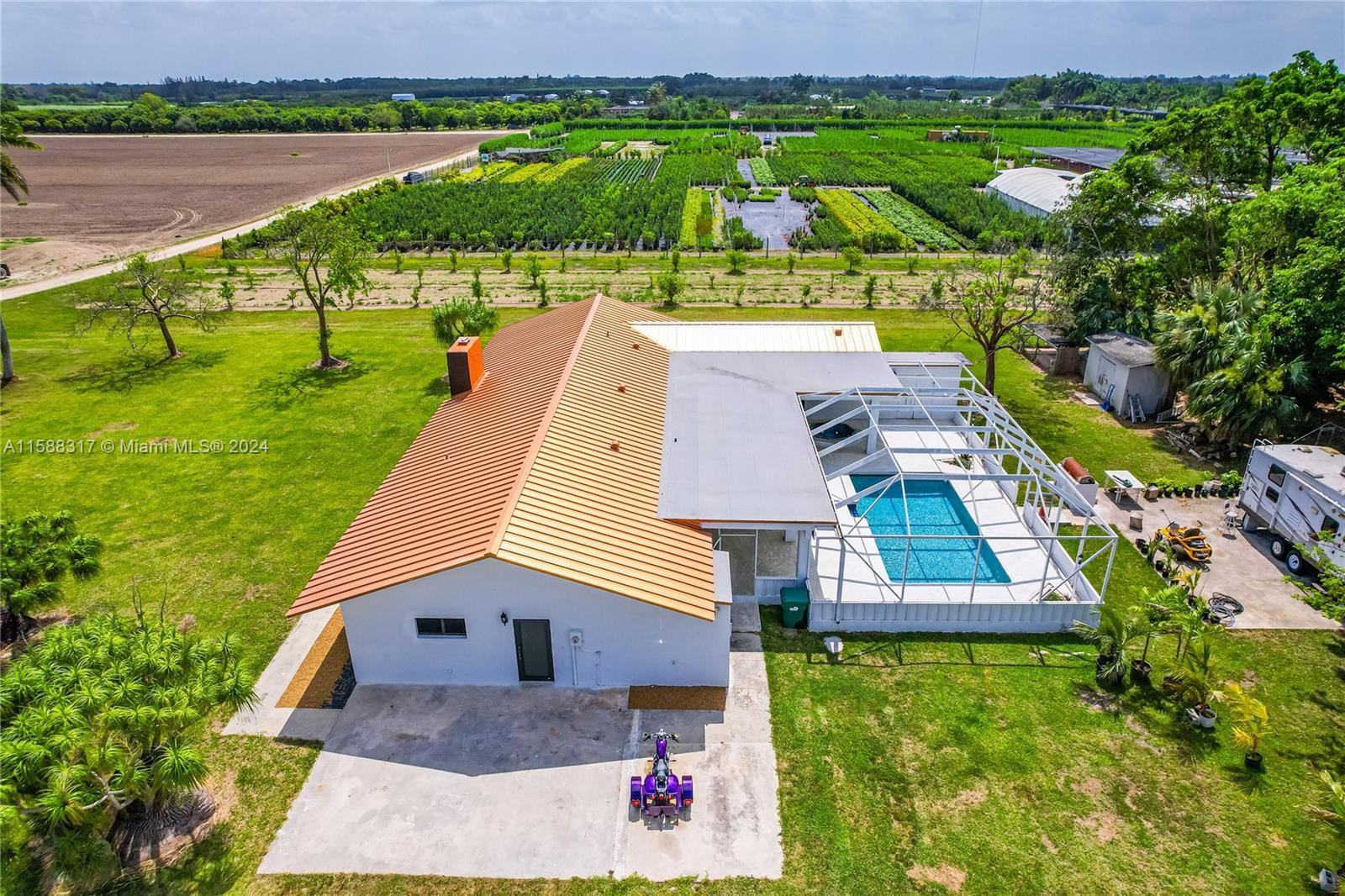 an aerial view of house with yard and lake view