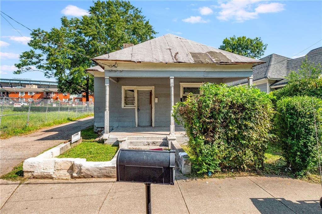 a front view of a house with a garden