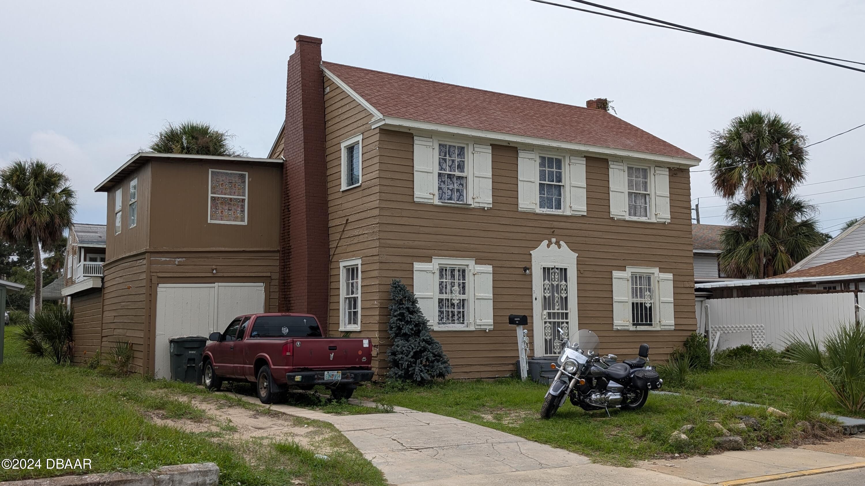 a front view of a house with a garden and porch