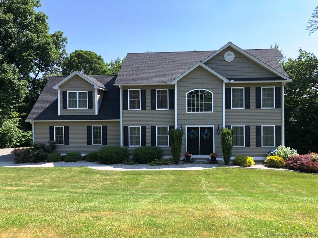 a front view of a house with a yard