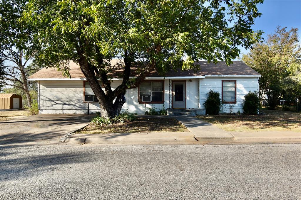 front view of house with large trees