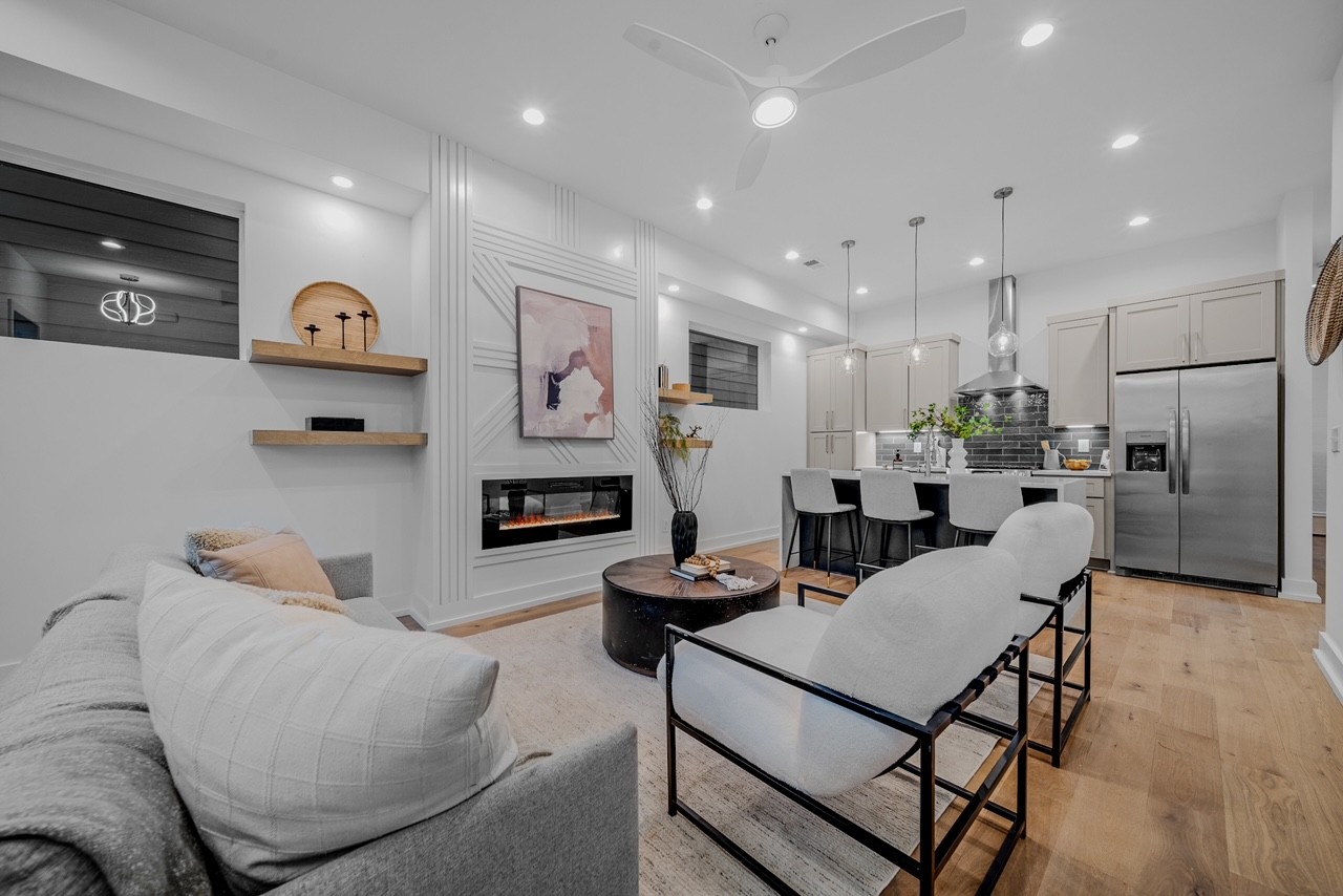 a living room with furniture and kitchen view