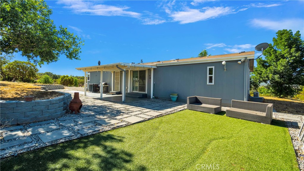 a view of a backyard with sitting area