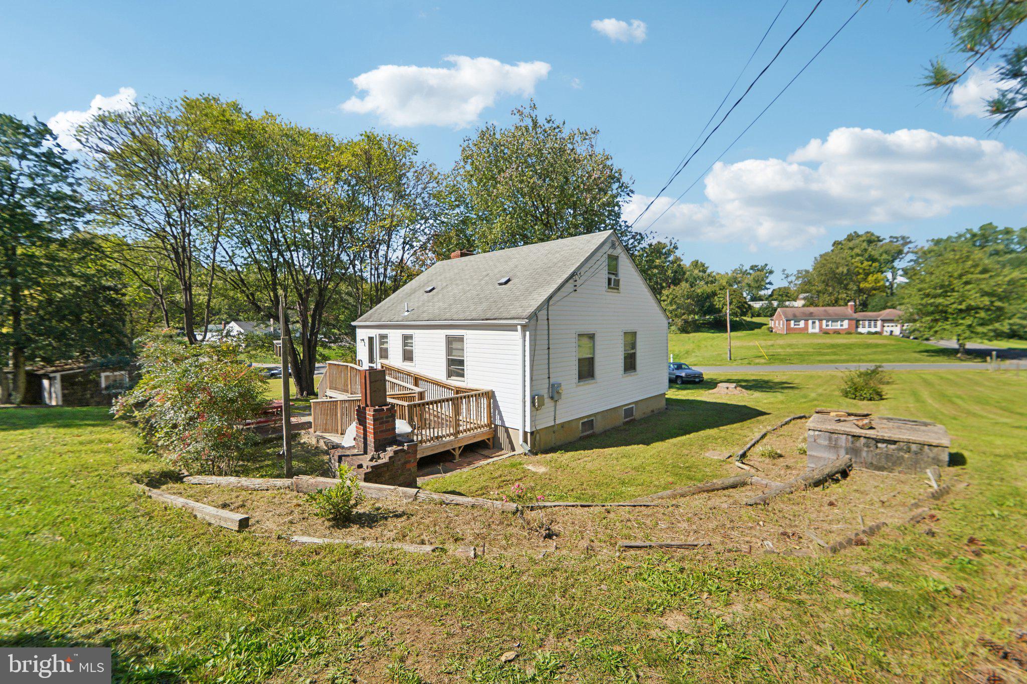 a view of a house with a yard and sitting area