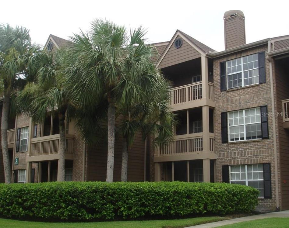 a front view of a building with a garden