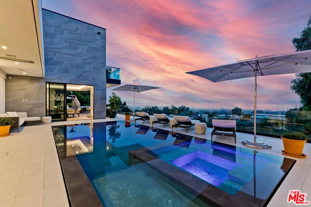 a living room with patio furniture and a potted plant