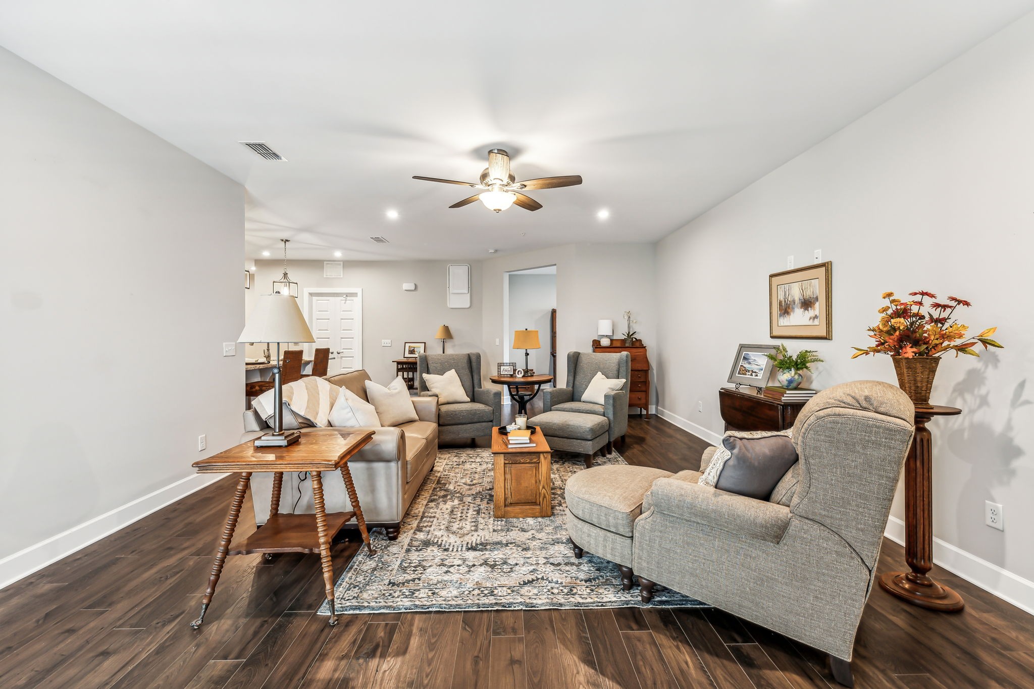 a living room with furniture and wooden floor