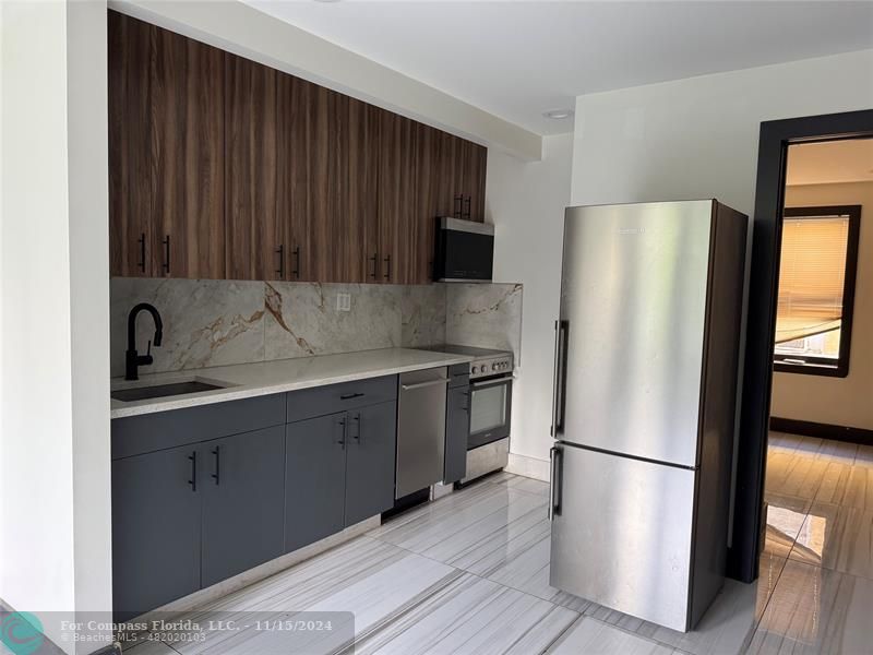 a kitchen with stainless steel appliances a refrigerator and a sink