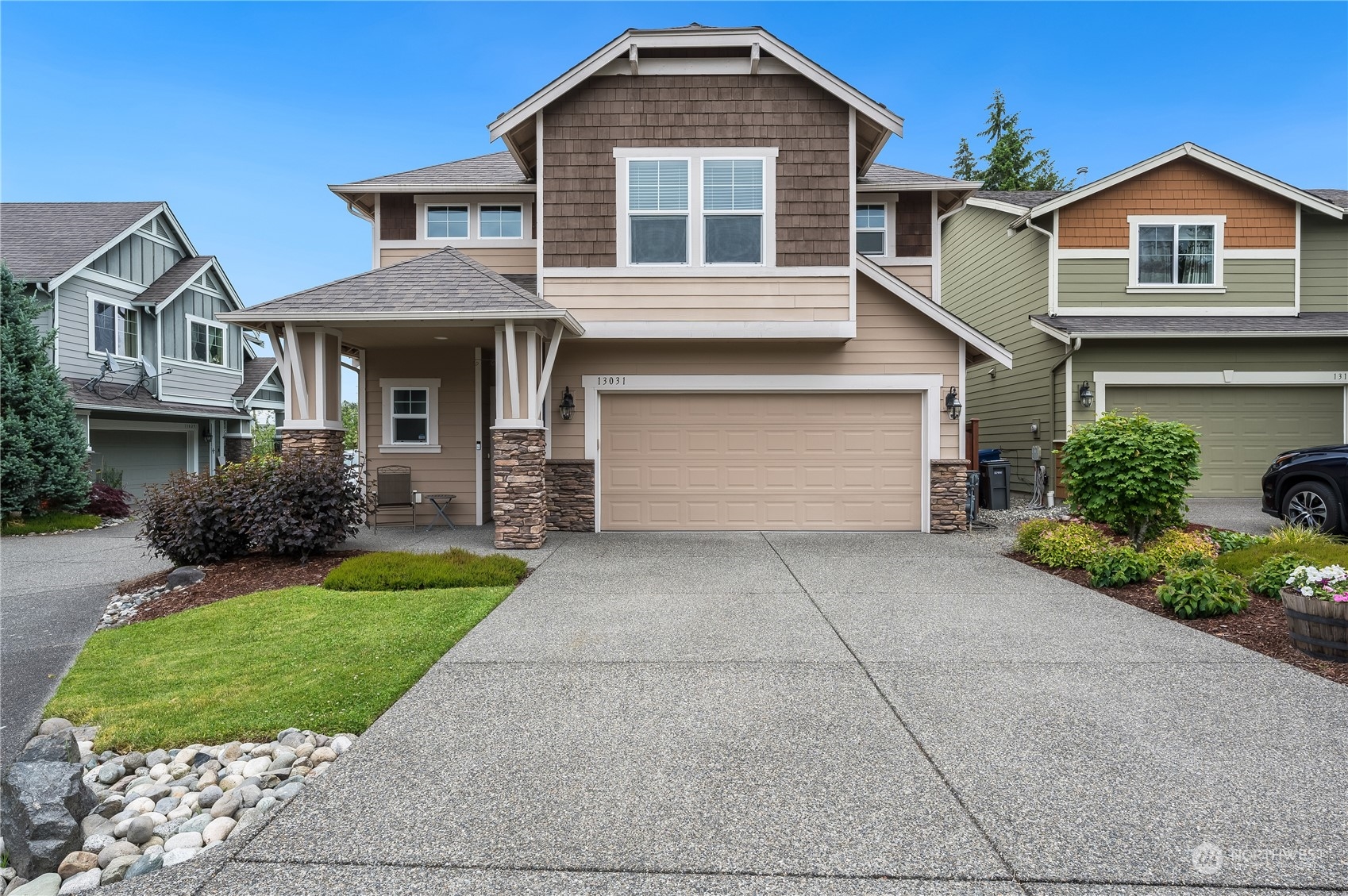 a front view of a house with a yard and garage