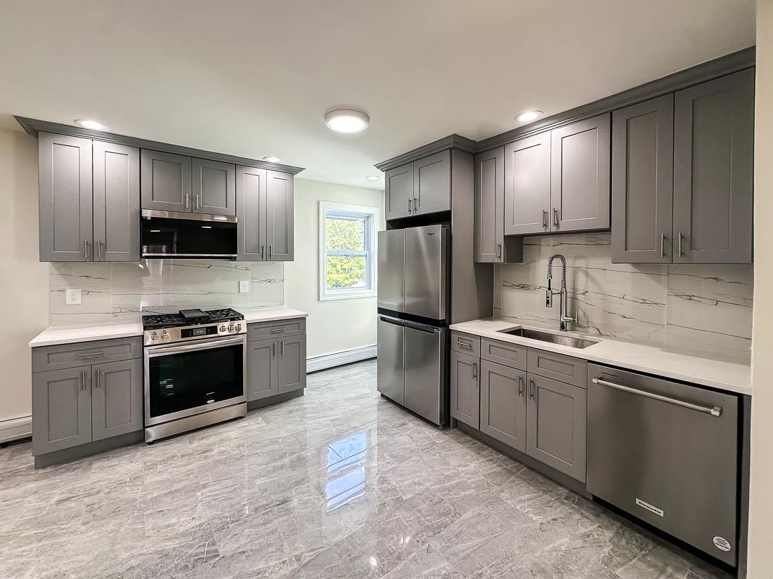 a kitchen with stainless steel appliances granite countertop a refrigerator stove a sink and dishwasher