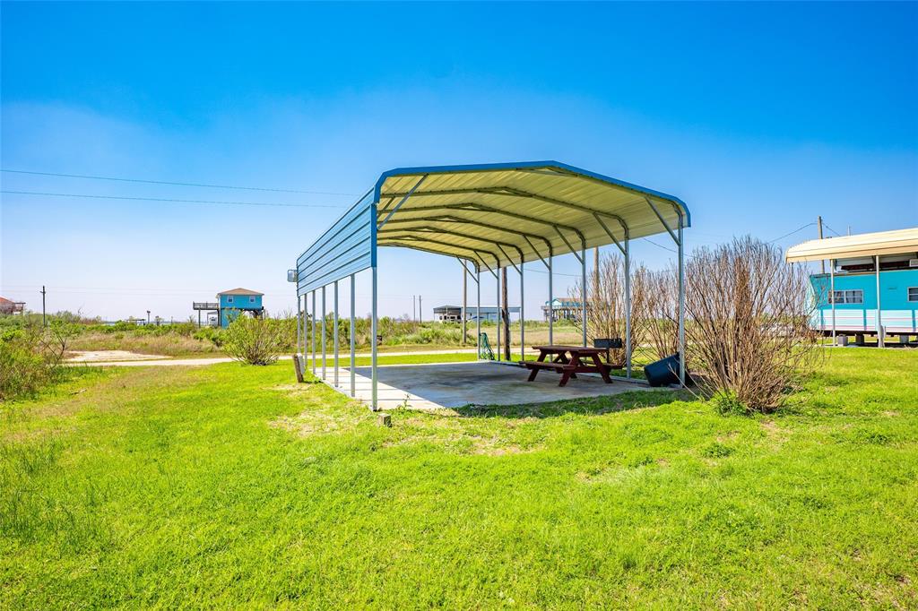 a view of a swimming pool with a table and chairs under an umbrella