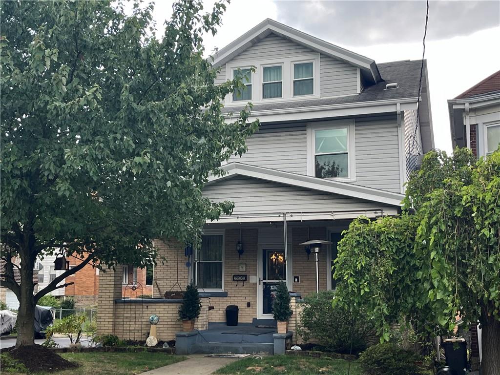 a view of a house with a yard and potted plants