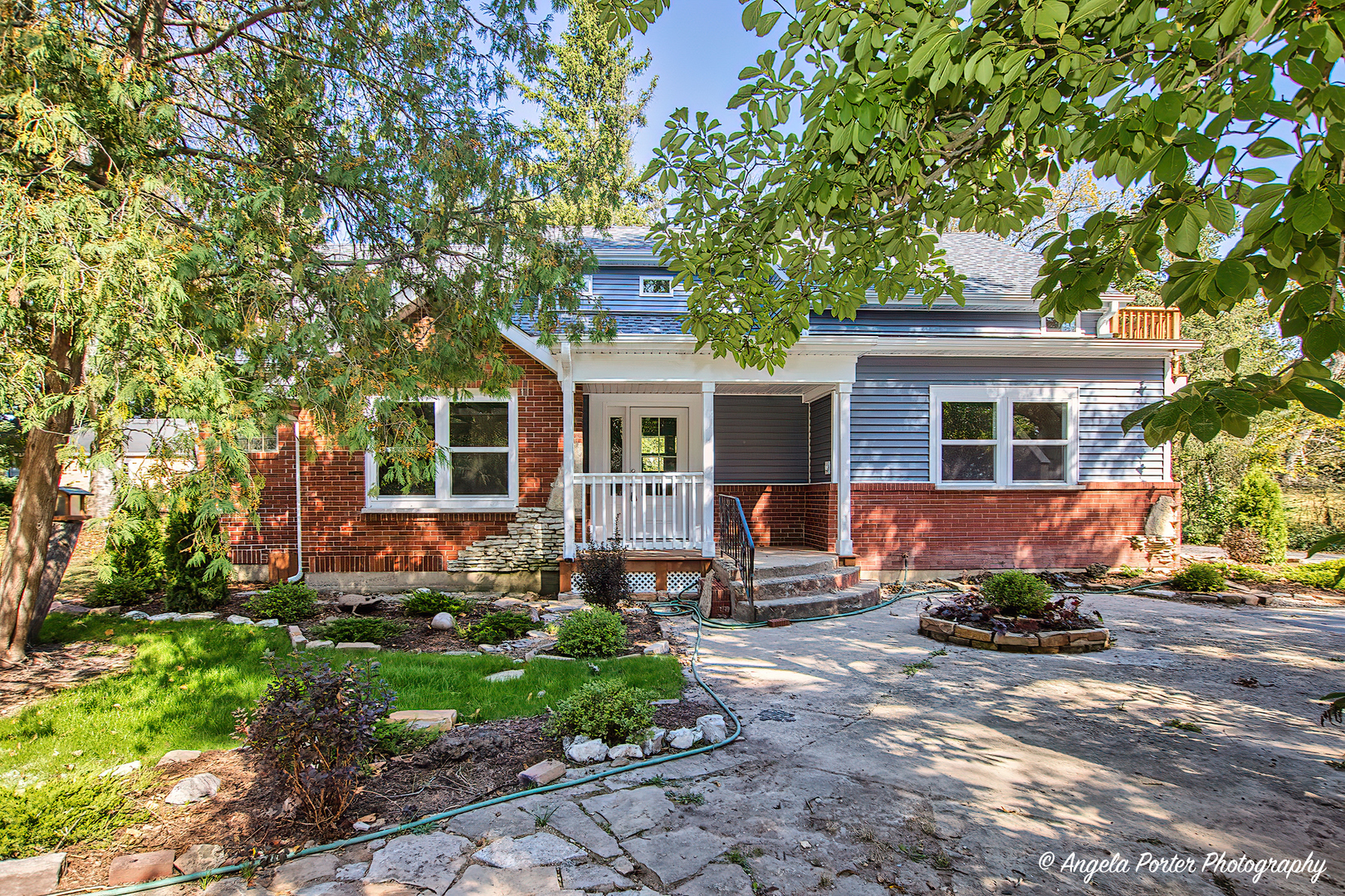 a front view of a house with garden