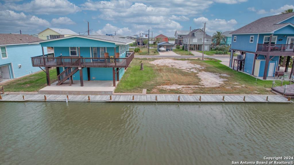 a view of a house with a yard from a lake view