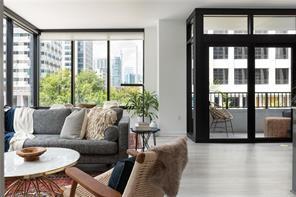 a living room with furniture and a floor to ceiling window