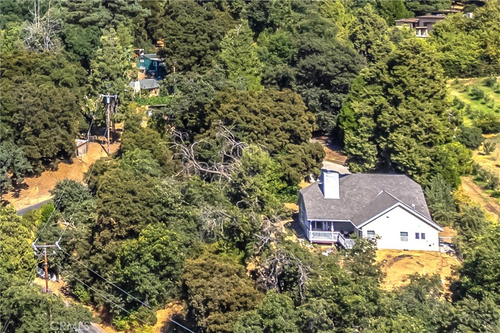 an aerial view of residential house with parking and yard