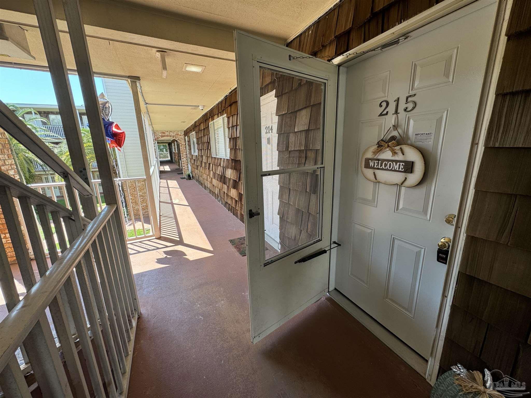 a view of an entryway with wooden floor