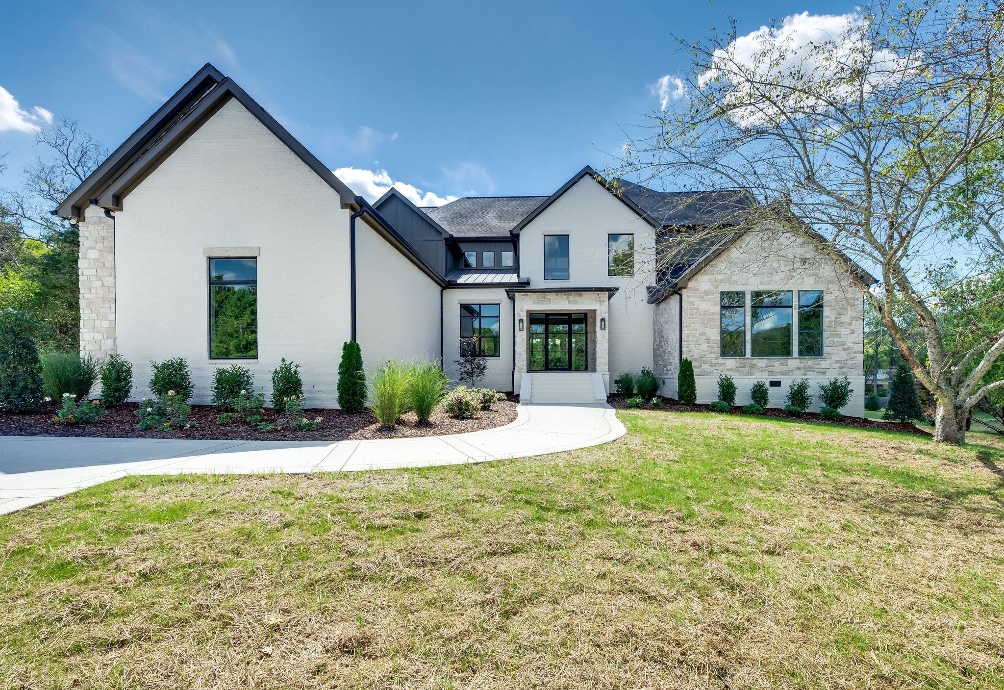 a front view of a house with a yard and garage