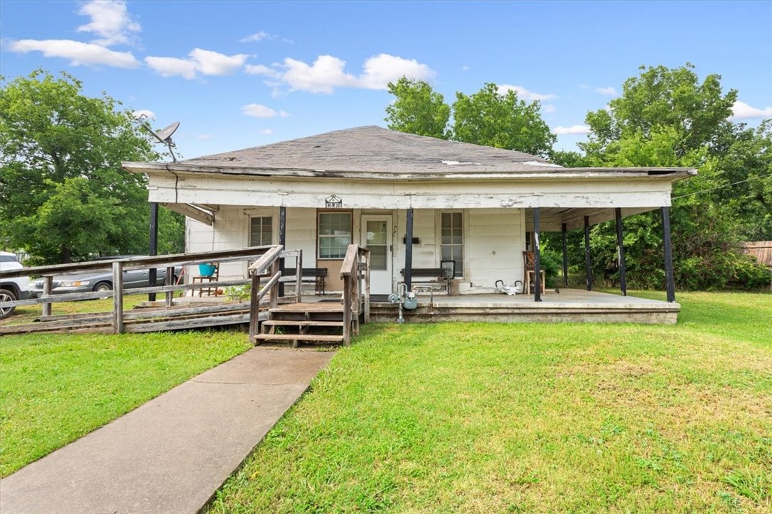 a view of a house with a yard patio and swimming pool