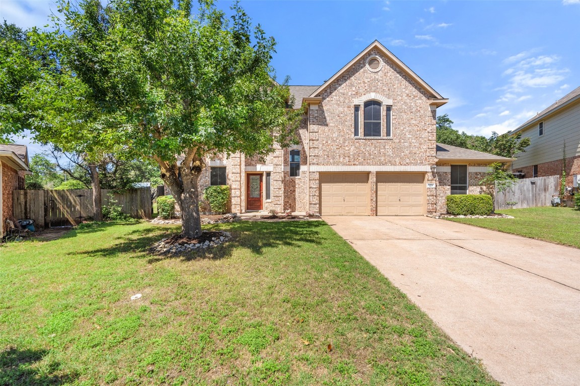 a front view of a house with a yard and garage