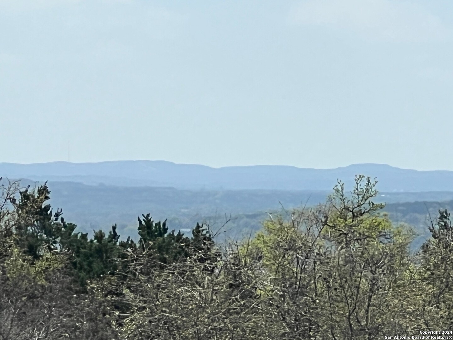 an aerial view of mountain with green space