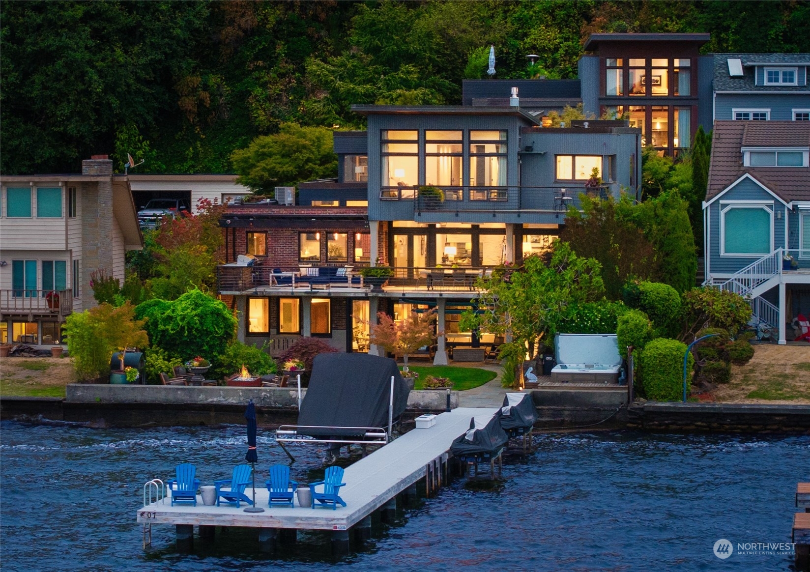 a view of a house with backyard water fountain and sitting area