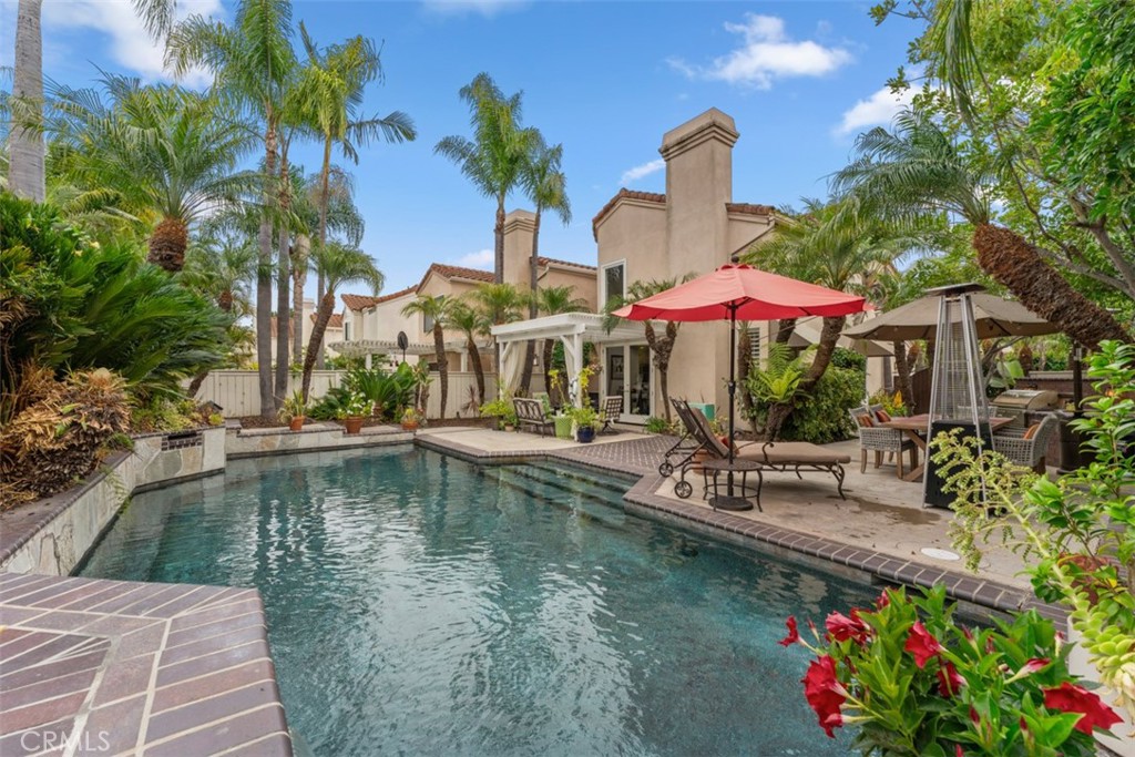 a small pool with outdoor seating and yard