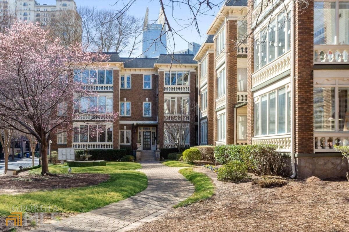 a view of a brick building next to a yard