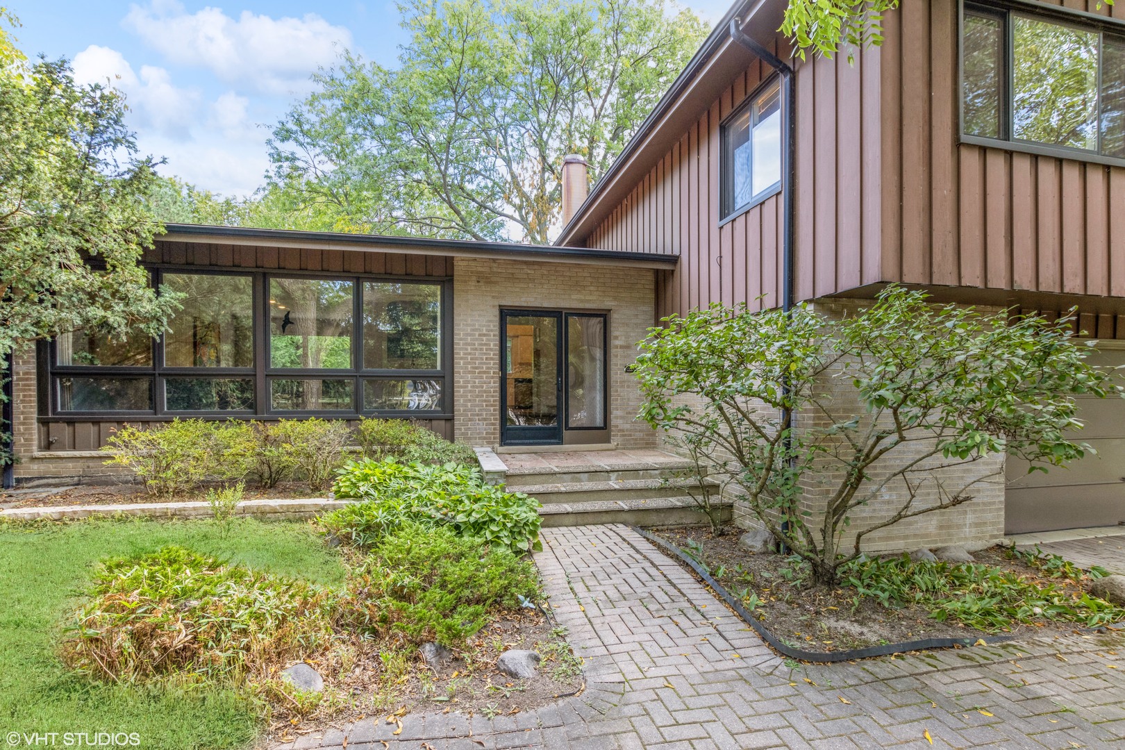 a front view of a house with garden