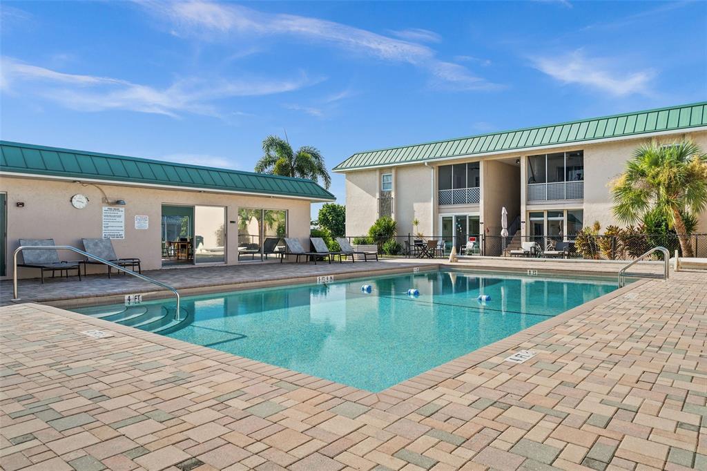 a view of a house with swimming pool and sitting area