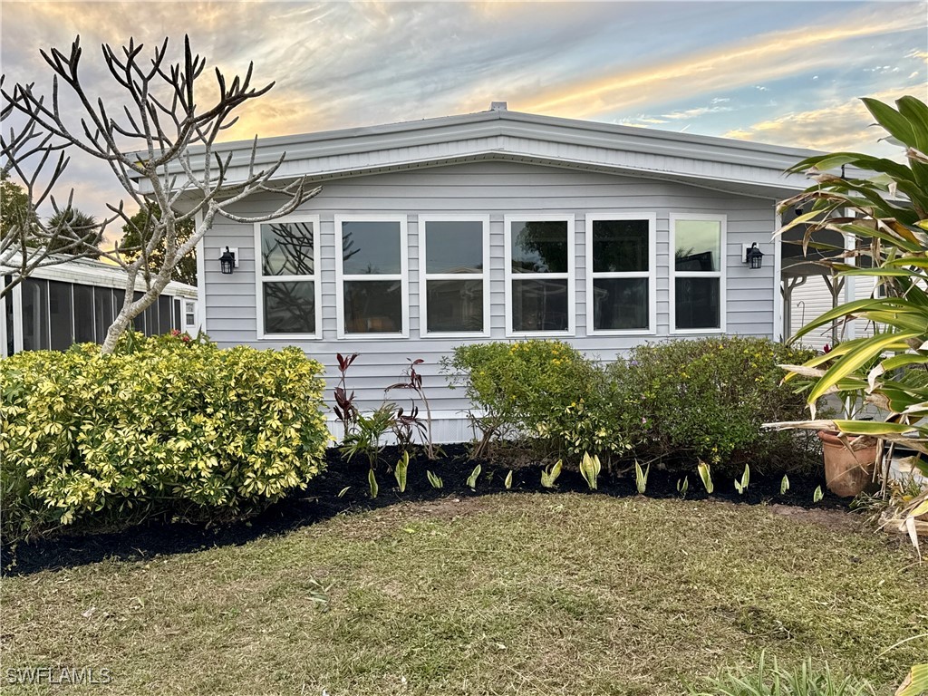 a front view of a house with a garden