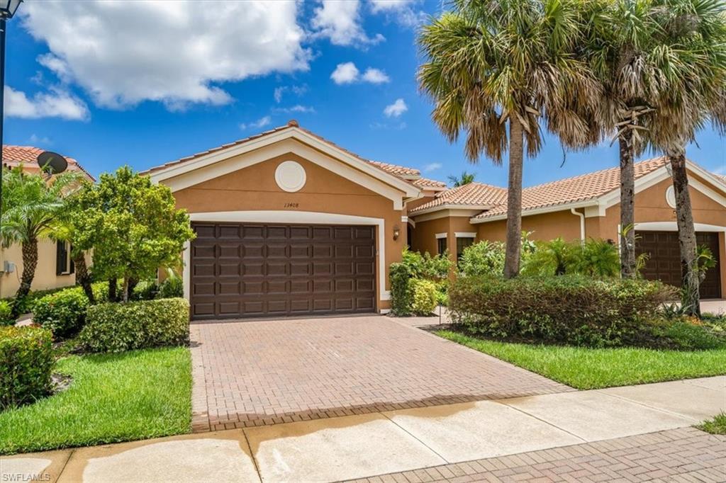 a front view of a house with a yard and garage