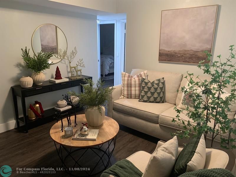 a living room with furniture and a potted plant