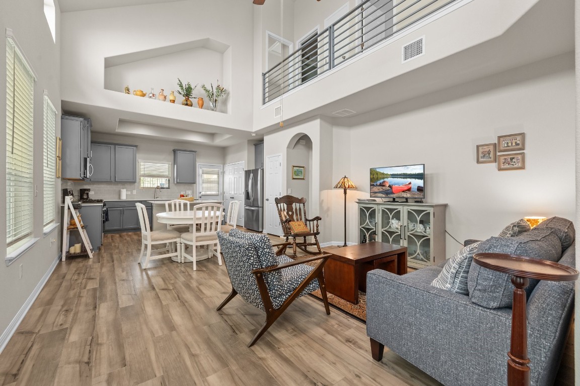 a living room with furniture and a wooden floor