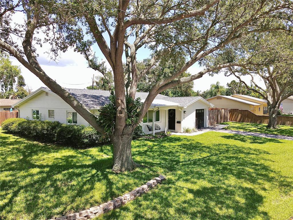 a front view of house with yard and green space