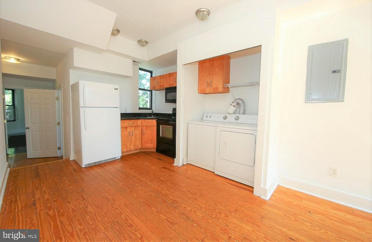 a view of a kitchen with a sink and a refrigerator