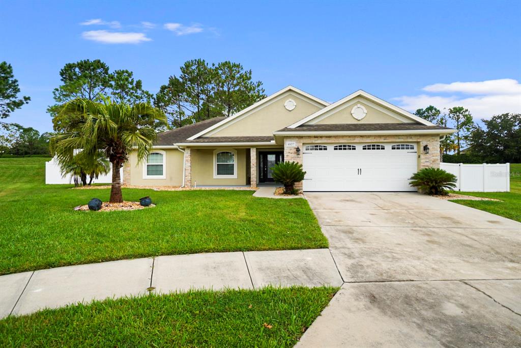 a front view of a house with a yard and garage