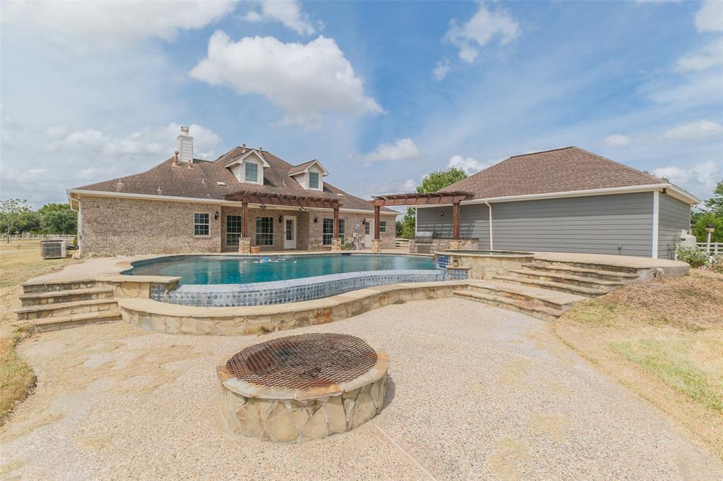 a front view of a house with swimming pool and porch