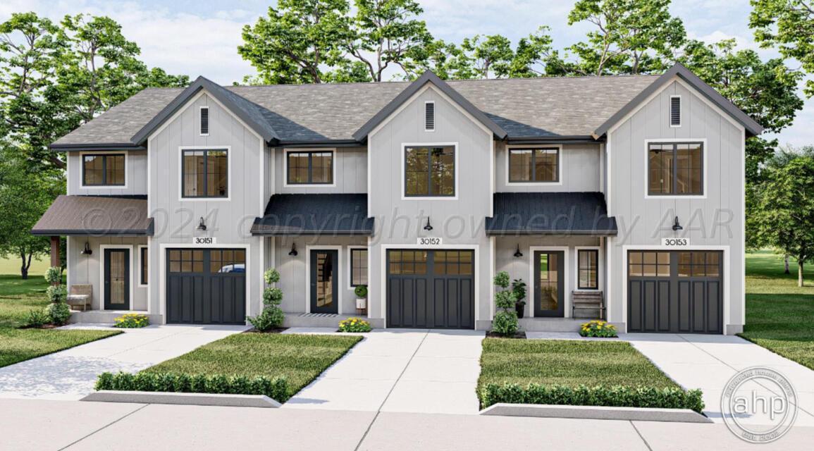 a front view of a house with a yard and a garage