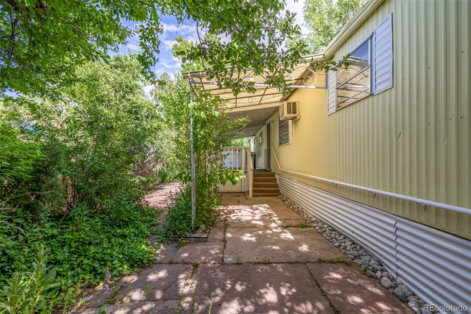 a view of a pathway both side of the house