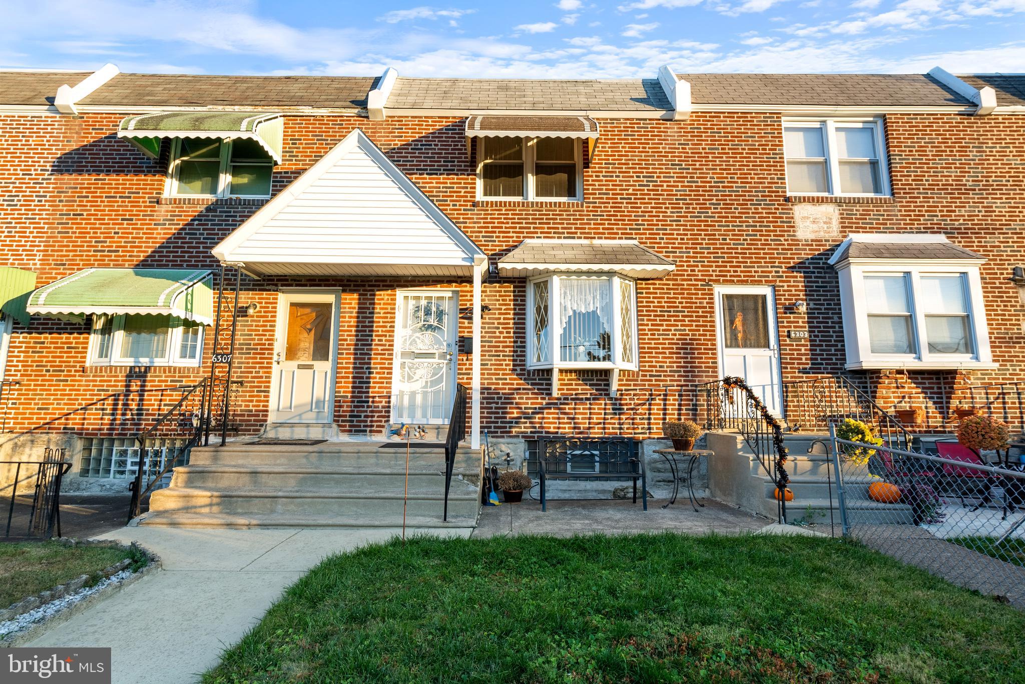 a front view of a house with a yard table and chairs