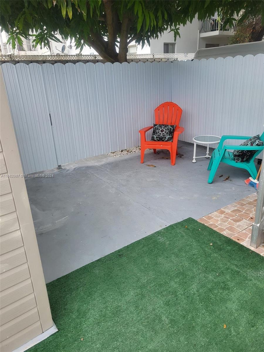 a backyard of a house with table and chairs